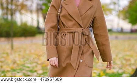 Front View Torso Of Woman Walking Around Park In Coat. High Quality Photo