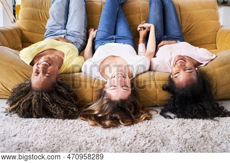 Three Girlfriends Women Happy Smiling At Sofa Laugh Good. Young People Having Fun Together At Home.