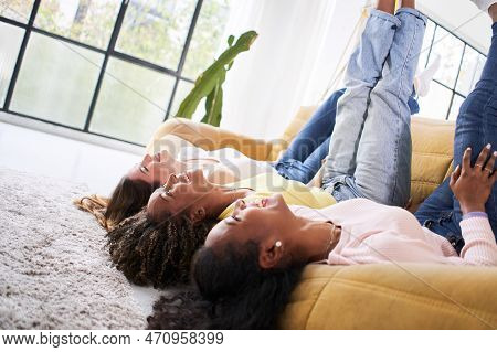 Three Happy Woman Laughing And Having Fun Together At Sofa Home. Smiling Female Friends Indoors Life