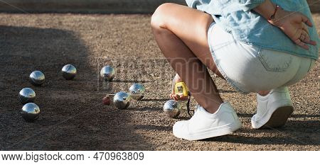 Petanque Game, Woman Measuring The Distance Of Petanque Ball In Petanque Field, Deciding Who's The W