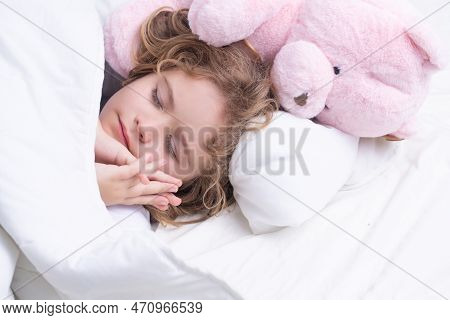 Comfortable Bed, Soft Pillow Orthopedic Mattress. Child Sleeping With A Toy Teddy Bear On Bed At Hom