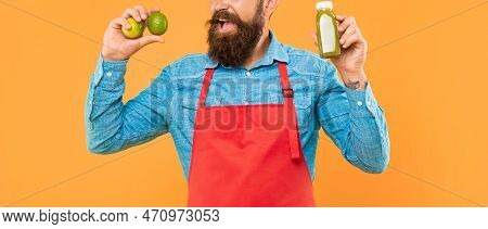 Man Crop View In Apron Holding Lime And Juice Bottle Yellow Background, Juicery