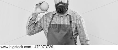 Serious Man Crop View In Red Apron Holding Fresh Orange Citrus Fruit Yellow Background, Fruiterer