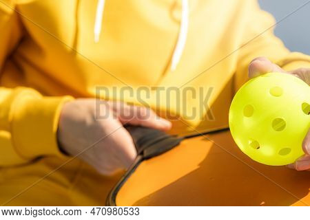 Pickleball Paddle And Yellow Ball Close Up, Woman Playing Pickleball Game, Hitting Pickleball Yellow