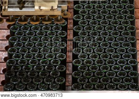 Production Of Cremant Sparkling Wine In Burgundy, France. Automatically Powered Bottling And Riddlin