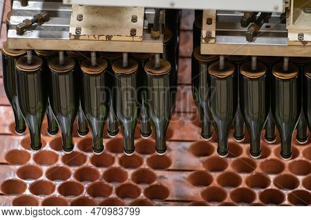 Production Of Cremant Sparkling Wine In Burgundy, France. Automatically Powered Bottling And Riddlin