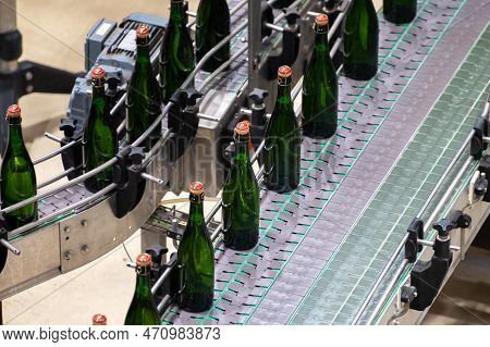 Production Of Cremant Sparkling Wine In Burgundy, France. Automatically Powered Bottling And Corking