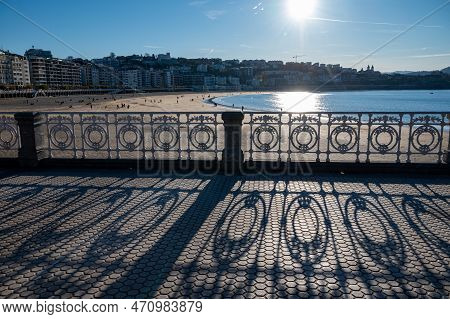 Walking On Promenade Along White Sandy La Concha Beach In Central Part Of Donostia Or San Sebastian