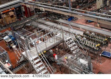 Production Of Cremant Sparkling Wine In Burgundy, France. Automatically Powered Bottling Lines On Fa