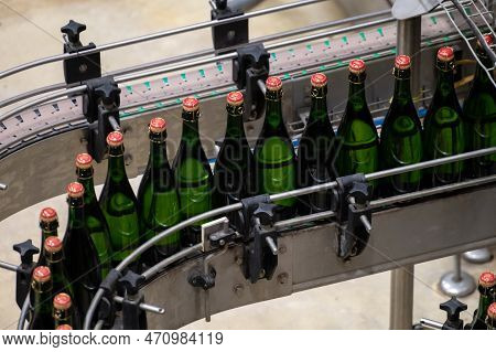 Production Of Cremant Sparkling Wine In Burgundy, France. Automatically Powered Bottling And Corking