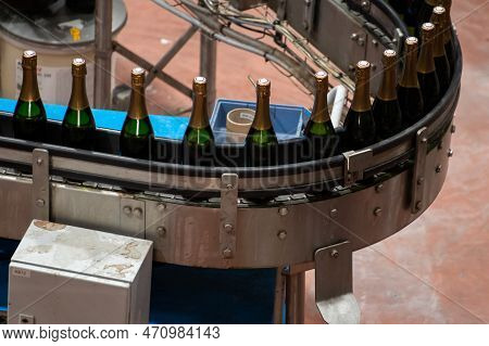 Production Of Cremant Sparkling Wine In Burgundy, France. Automatically Powered Bottling Lines On Fa