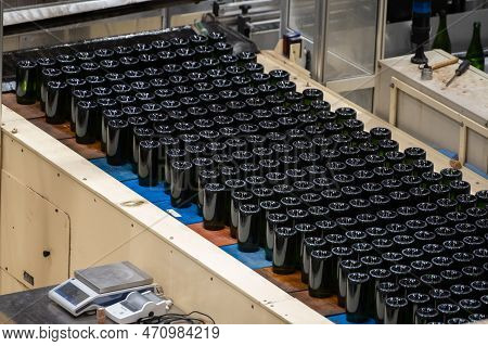 Production Of Cremant Sparkling Wine In Burgundy, France. Automatically Powered Bottling And Riddlin
