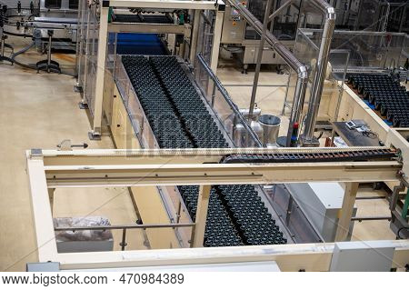 Production Of Cremant Sparkling Wine In Burgundy, France. Automatically Powered Bottling Lines On Fa