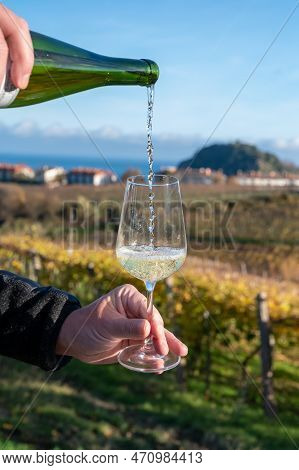 Pouring Of Txakoli Or Chacolí Slightly Sparkling Very Dry White Wine Produced In Spanish Basque Coun