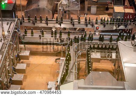 Production Of Cremant Sparkling Wine In Burgundy, France. Automatically Powered Bottling Lines On Fa
