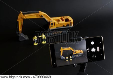 Smartphone On Gimbal Selfie Stick For Photo-video Filming Toy Excavator And Construction Workers. Co