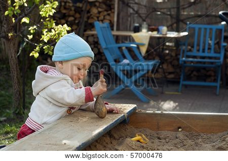 Child Playing At Sandbox