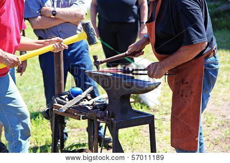 Black smith fixing a horse shoe