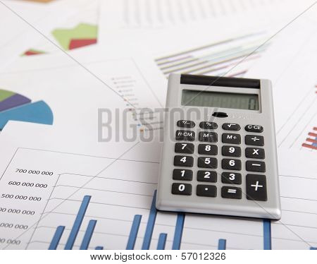 A business strategy concept with a calculator and color charts