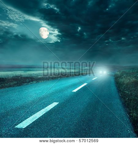 Driving On Asphalt Road At Night Towards The Headlights