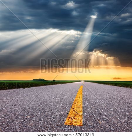Driving On Asphalt Road Towards The Sunbeams