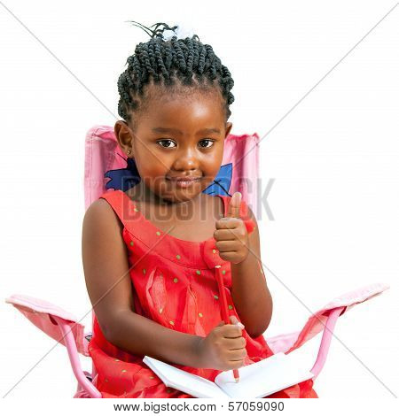 Sweet African Kid With Note Book And Thumbs Up.