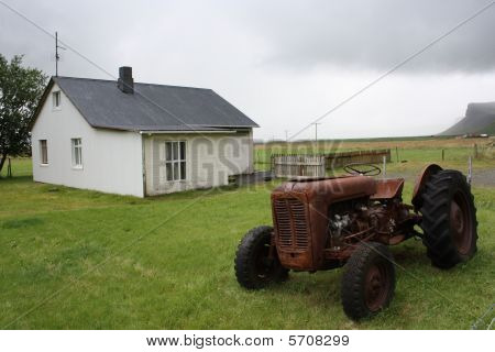 vida en la granja, traktor viejo por una casa rural completa