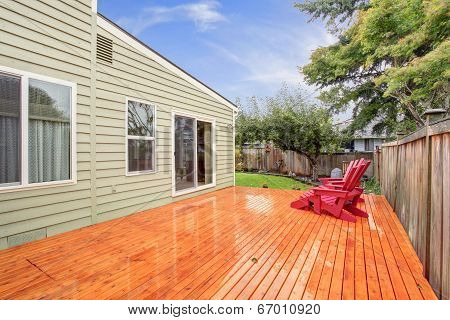 Wooden Deck With Red Chairs