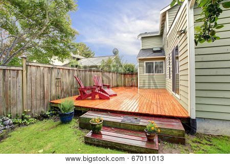 Wooden Deck With Red Chairs