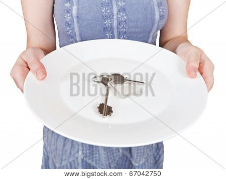 Woman Holds White Plate With Door Keys
