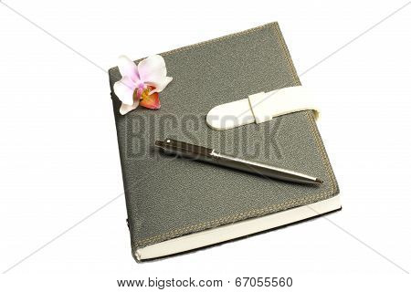 Notebook With Pen And Flower And Orchid