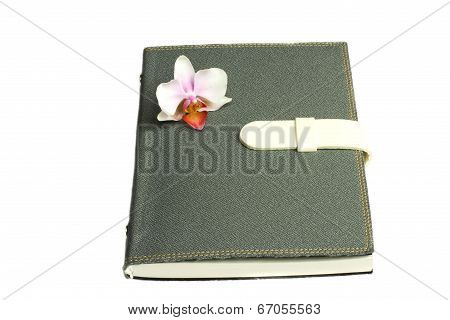 Notebook With Pen And Flower And Orchid