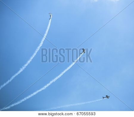 BERLIN, GERMANY - MAY 21, 2014: Aerobatic team 3x Fly Sinthesis Texan Top Class (Wefly team, Italy) demonstration during the International Aerospace Exhibition ILA Berlin Air Show-2014.