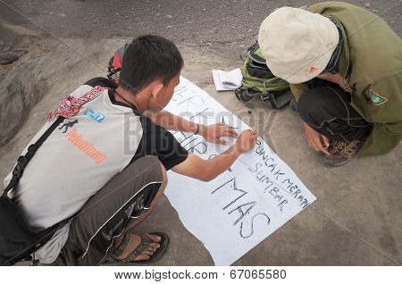 Indonesian Students Write Poster For Pictures On The Top Of Volcano Merapi
