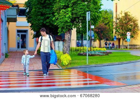 Father And Son Crossing The City Street On Crosswalk