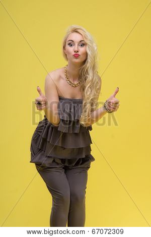 Woman standing on yellow background