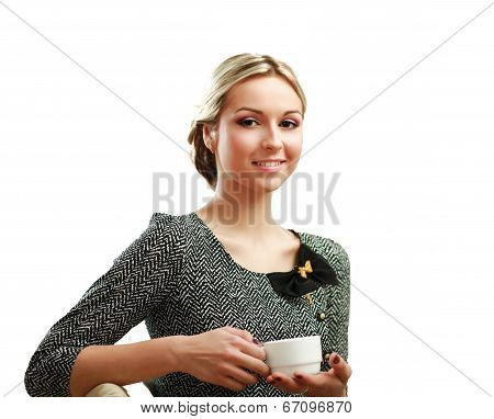 young woman holding a cup of coffee at her workplace