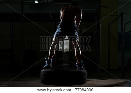 Athletic Man Hits Tire