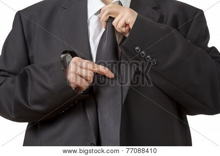 Man In Siut Straightening His Tie