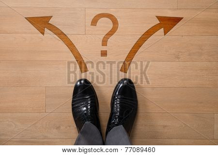 Businessman With Left Or Right Arrows And Question Mark