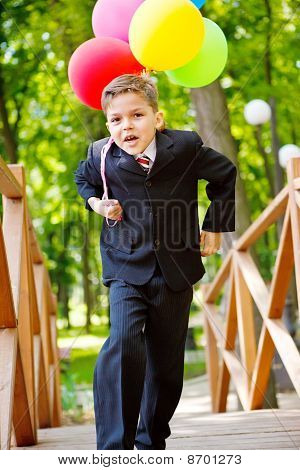 Cheerful Boy With Balloons