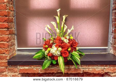 Bouquet Of Red Amarillis On A Window Sill