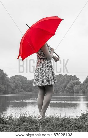 Girl With Red Umbrella Stands Near The Pond