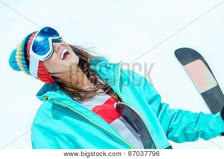Girl Skier Resting In The Snow, Watching The Sun With A Smile