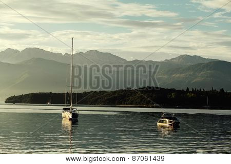 Yacht And Pleasure Boat At Sunset With Mountains In Kotor Bay, Montenegro