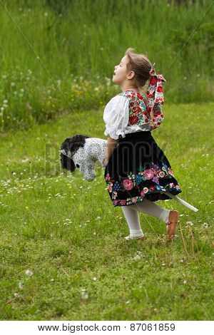 Little Girl Playing On A Meadow