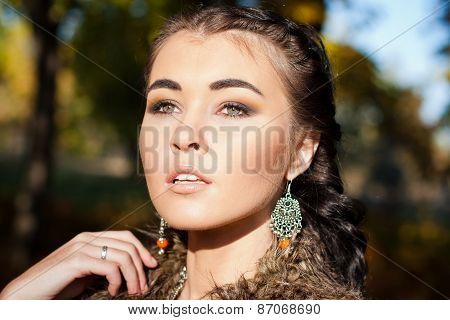 Beautiful woman over autumn leaves