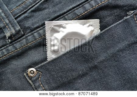 Condom in the blue jeans pocket