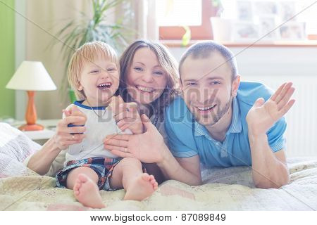 Young Attractive Parents and Child Portrait indoors