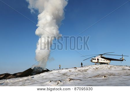 Tourists And Helicopter Near The Erupting Tolbachik Volcano. Kamchatka Peninsula